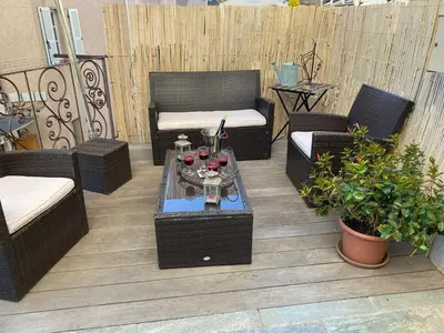 a patio with couches and a table with glasses of wine at A Stella in Borgo