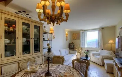 a living room with a couch and a chandelier at A Stella in Borgo