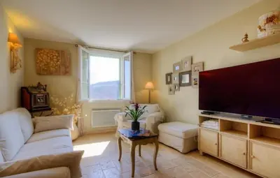 a living room with a couch and a tv at A Stella in Borgo