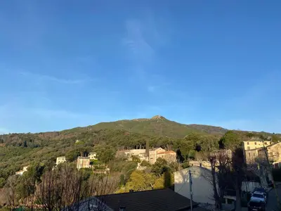 a view of a mountain with houses and trees at A Stella in Borgo