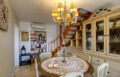 a dining room table with chairs and a chandelier at A Stella in Borgo