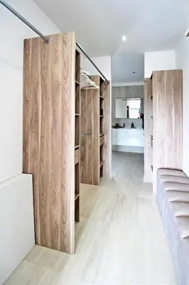 a room with wooden dividers in a house at Villa PIETRA 300m de la plage de Favone Piscine privée chauffée in Conca