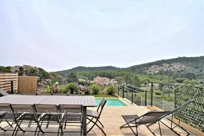 a patio with a table and chairs and a pool at Villa PIETRA 300m de la plage de Favone Piscine privée chauffée in Conca