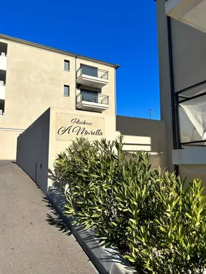 a building with a sign that reads la marina at T1 de standing avec vue in Corte