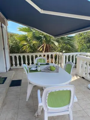 a white table and chairs on a patio at Appartement T2 Olmeto in Olmeto