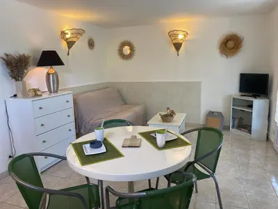 a living room with a white table and chairs at Appartement T2 Olmeto in Olmeto