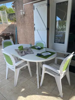 a white table and chairs on a patio at Appartement T2 Olmeto in Olmeto