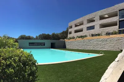 a large swimming pool in front of a building at Grand Studio moderne tout confort in Porto-Vecchio