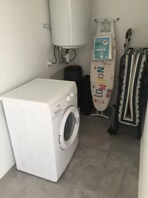 a washer and dryer in a kitchen with a washing machine at Grand Studio moderne tout confort in Porto-Vecchio