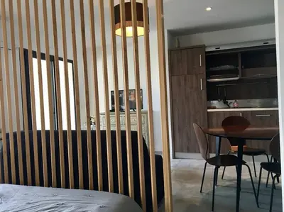 a bedroom with a bed and a table and chairs at Grand Studio moderne tout confort in Porto-Vecchio
