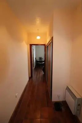 a hallway with a room with a television and a floor at Studio face mer Porticcio, proche aéroport Ajaccio in Porticcio