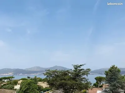 a view of the water with trees in the foreground at Studio face mer Porticcio, proche aéroport Ajaccio in Porticcio