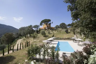 a resort with a swimming pool and a house on a hill at Le Domaine Saint François Le Moulin 1 in Ajaccio