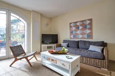 a living room with a couch and a table at Le Domaine Saint François Le Moulin 1 in Ajaccio