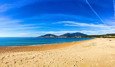a sandy beach with a view of the ocean at A LIVIA Peri Ajaccio in Peri