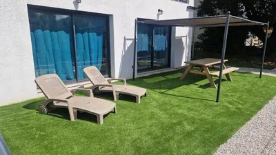 two chairs and a picnic table on a lawn at A LIVIA Peri Ajaccio in Peri