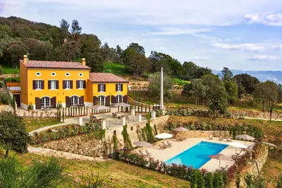 an exterior view of a yellow house with a swimming pool at Le Domaine Saint François Le Moulin 2 in Ajaccio