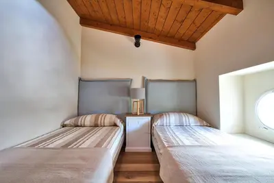 two beds in a room with a window at Le Domaine Saint François La Tour 1 in Ajaccio