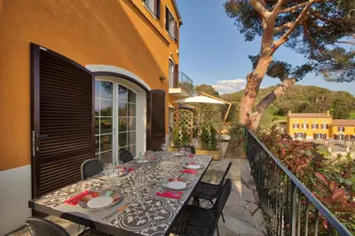 a dining table on the balcony of a house at Le Domaine Saint François La Tour 1 in Ajaccio