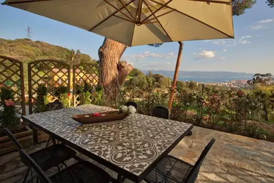 a table and chairs with an umbrella on a patio at Le Domaine Saint François la Tour 2 in Ajaccio