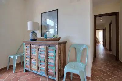 a room with two chairs and a dresser and a mirror at Le Domaine Saint François La Tour 3 in Ajaccio