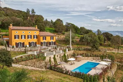 an exterior view of a yellow house with a swimming pool at Le Domaine Saint François La Tour 3 in Ajaccio