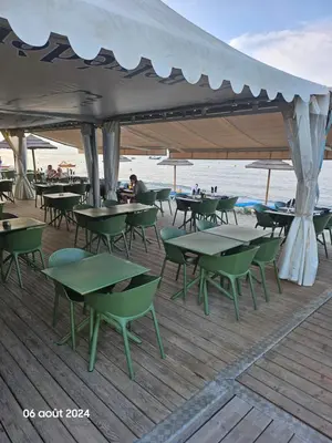 a group of tables and chairs on the beach at Maison Lido Marana plage in Borgo