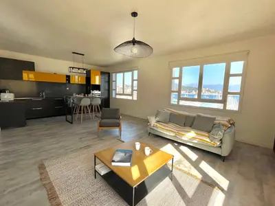 a living room with a couch and a table at Appartement centre ville Cours Napoléon AJACCIO in Ajaccio