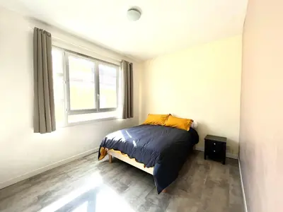 a bedroom with a bed and a window at Appartement centre ville Cours Napoléon AJACCIO in Ajaccio