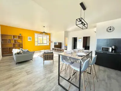 a kitchen and living room with a table and chairs at Appartement centre ville Cours Napoléon AJACCIO in Ajaccio