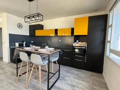 a kitchen with a table and chairs in a room at Appartement centre ville Cours Napoléon AJACCIO in Ajaccio