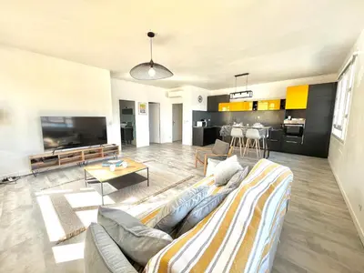 a living room with a couch and a table at Appartement centre ville Cours Napoléon AJACCIO in Ajaccio