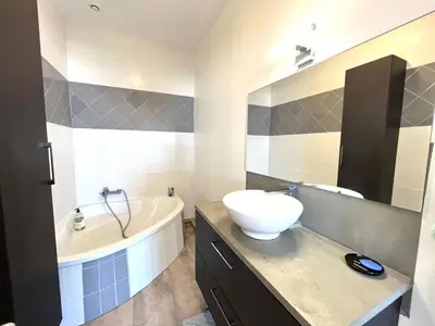 a bathroom with a sink and a bath tub and a sink at Appartement centre ville Cours Napoléon AJACCIO in Ajaccio