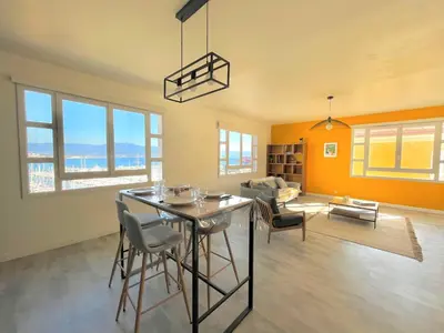 a kitchen and living room with a table and chairs at Appartement centre ville Cours Napoléon AJACCIO in Ajaccio