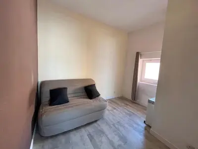 a living room with a couch with two pillows on it at Appartement centre ville Cours Napoléon AJACCIO in Ajaccio