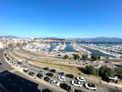 a parking lot with cars parked next to a marina at Appartement centre ville Cours Napoléon AJACCIO in Ajaccio