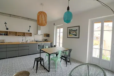 a kitchen with a table and chairs in a room at Appartement centre ville Citadelle Ajaccio in Ajaccio