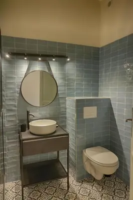 a bathroom with a sink and a toilet and a mirror at Appartement centre ville Citadelle Ajaccio in Ajaccio