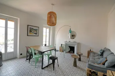 a living room with a table and chairs and a couch at Appartement centre ville Citadelle Ajaccio in Ajaccio