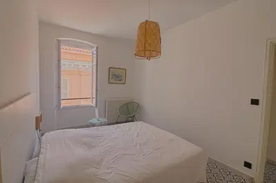 a bedroom with a bed and a window at Appartement centre ville Citadelle Ajaccio in Ajaccio