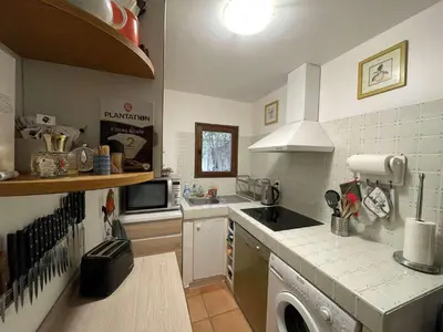 a kitchen with a sink and a stove top oven at Maison Asco à Santa Giulia in Porto-Vecchio
