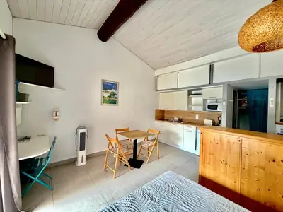 a kitchen and dining room with a table and chairs at Villa Occhiatana, Santa Giulia in Porto-Vecchio