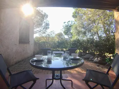 a table and chairs on a patio at Villa Occhiatana, Santa Giulia in Porto-Vecchio