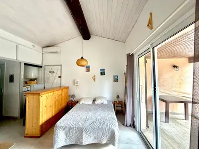 a bedroom with a bed and a large window at Villa Occhiatana, Santa Giulia in Porto-Vecchio