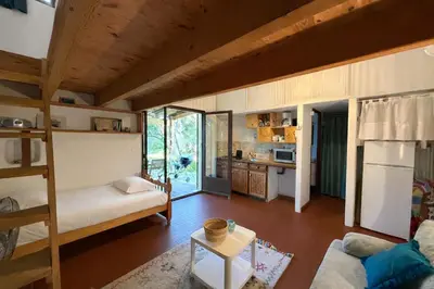 a living room with a bunk bed and a kitchen at Mini villa Centuri, Santa Giulia in Porto-Vecchio