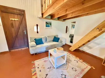 a living room with a couch and a table at Mini villa Centuri, Santa Giulia in Porto-Vecchio