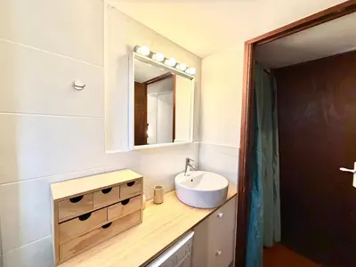 a bathroom with a sink and a mirror at Mini villa Centuri, Santa Giulia in Porto-Vecchio