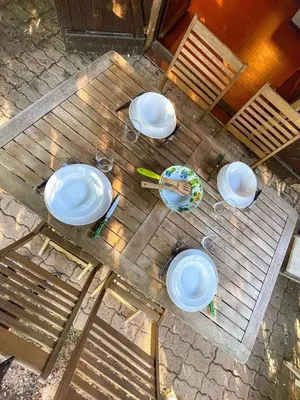 an overhead view of a wooden table with plates on it at Mini villa Centuri, Santa Giulia in Porto-Vecchio