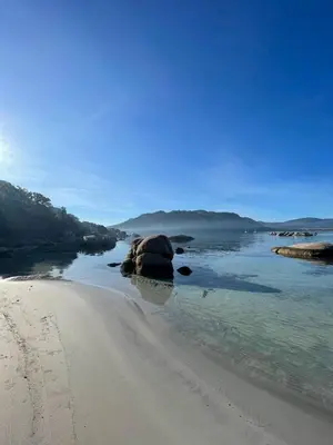 a sandy beach with rocks in the water at Mini villa Erbalunga, Santa Giulia in Porto-Vecchio