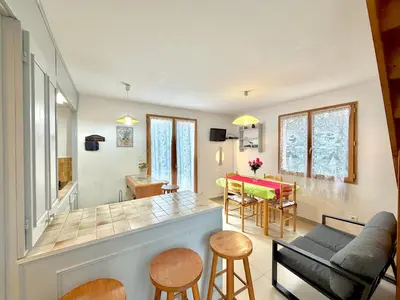 a living room with a couch and a table at Mini villa Erbalunga, Santa Giulia in Porto-Vecchio